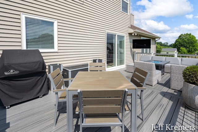 5692 Nile Dr SW, Wyoming, MI 49418 - wooden deck with outdoor dining area, outdoor lounge area, and a grill