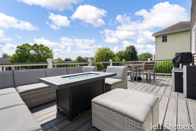 5692 Nile Dr SW, Wyoming, MI 49418 - wooden terrace featuring an outdoor living space with a fire pit, outdoor dining area, and area for grilling
