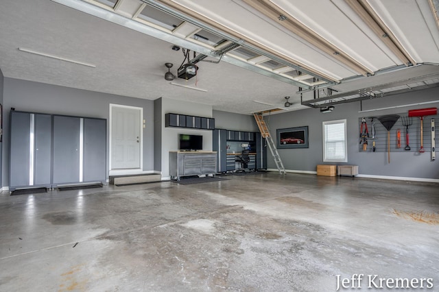 5692 Nile Dr SW, Wyoming, MI 49418 - garage featuring a garage door opener and baseboards