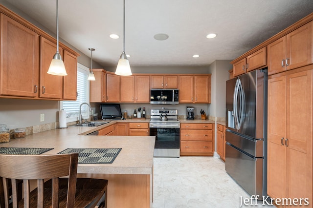 5692 Nile Dr SW, Wyoming, MI 49418 - kitchen featuring stainless steel appliances, a peninsula, light countertops, recessed lighting, and a breakfast bar