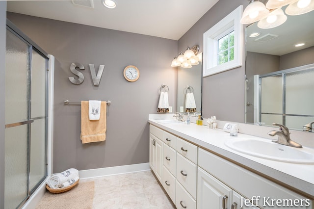5692 Nile Dr SW, Wyoming, MI 49418 - bathroom featuring double vanity, a shower stall, and recessed lighting