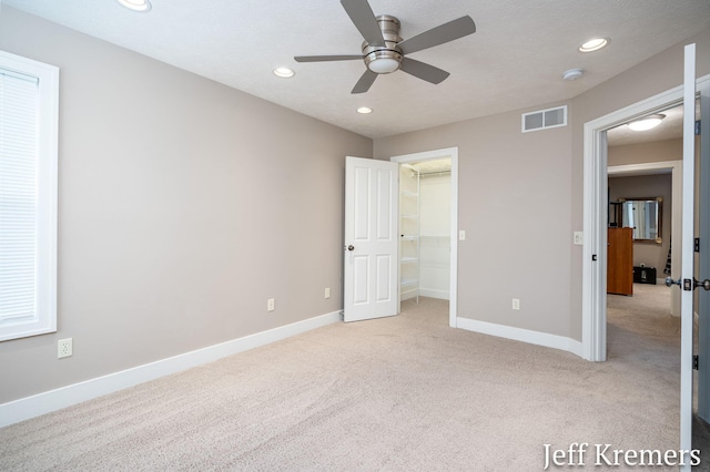 5692 Nile Dr SW, Wyoming, MI 49418 - unfurnished bedroom with light colored carpet, recessed lighting, a walk in closet, and ceiling fan