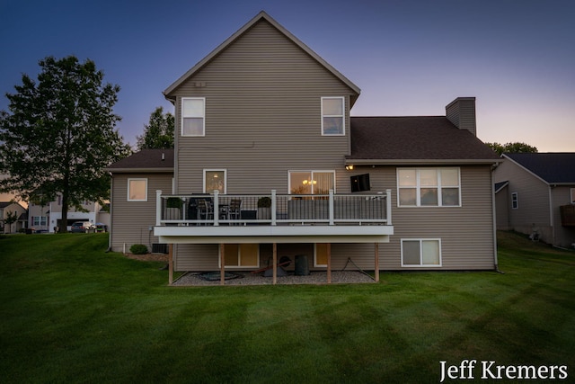5692 Nile Dr SW, Wyoming, MI 49418 - back of property featuring a yard, a chimney, a deck, and roof with shingles