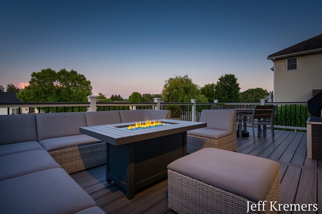 5692 Nile Dr SW, Wyoming, MI 49418 - deck at dusk with an outdoor living space with a fire pit