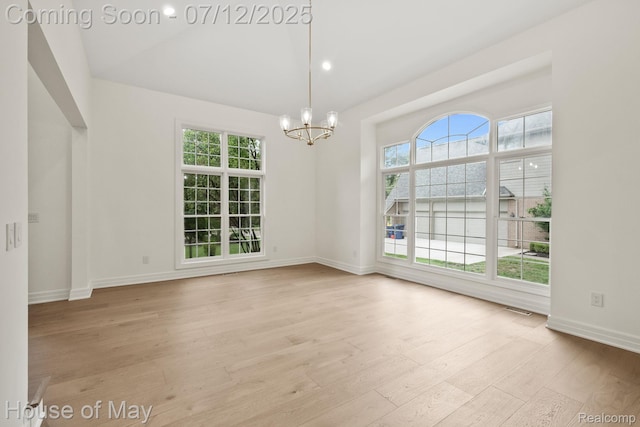 4743 S Ridge Dr, West Bloomfield, MI 48323 - empty room featuring a chandelier, light wood-style flooring, and high vaulted ceiling
