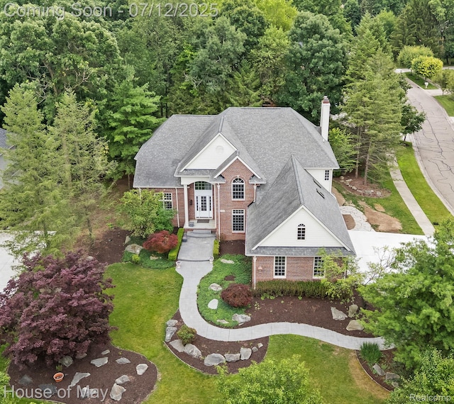 4743 S Ridge Dr, West Bloomfield, MI 48323 - view of front of house with brick siding, a chimney, and a front lawn