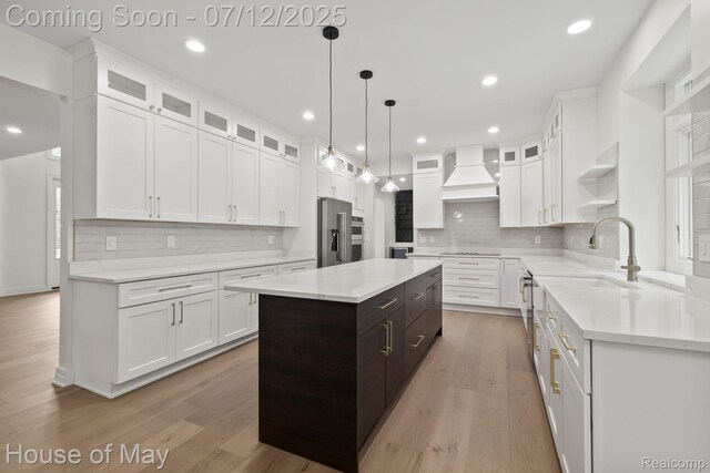 4743 S Ridge Dr, West Bloomfield, MI 48323 - kitchen with premium range hood, white cabinetry, decorative backsplash, stainless steel appliances, and recessed lighting