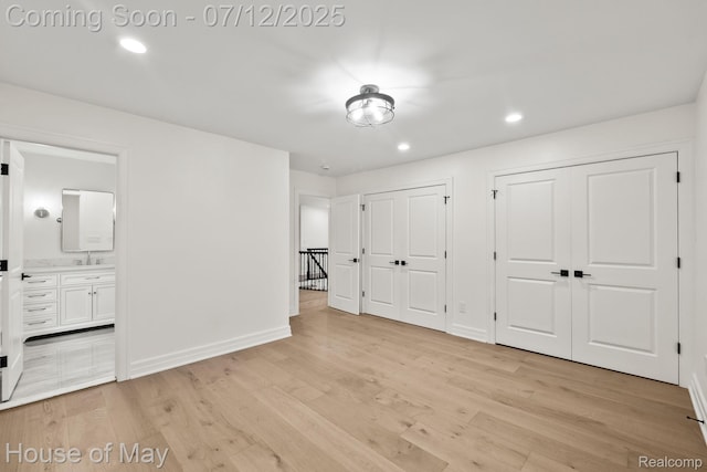 4743 S Ridge Dr, West Bloomfield, MI 48323 - unfurnished bedroom featuring multiple closets, light wood-type flooring, recessed lighting, and ensuite bathroom