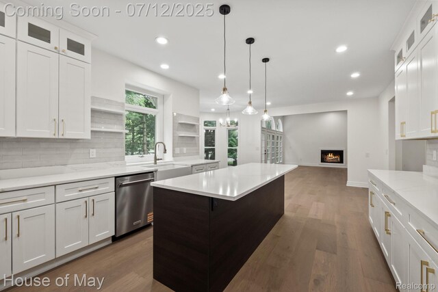4743 S Ridge Dr, West Bloomfield, MI 48323 - kitchen with stainless steel dishwasher, recessed lighting, open shelves, a lit fireplace, and tasteful backsplash