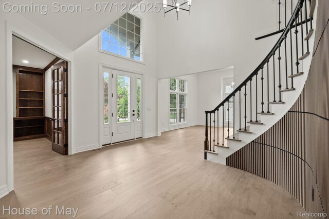4743 S Ridge Dr, West Bloomfield, MI 48323 - entrance foyer featuring wood finished floors, stairway, a towering ceiling, and a chandelier