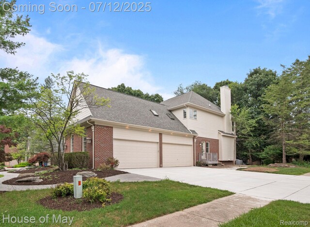 4743 S Ridge Dr, West Bloomfield, MI 48323 - view of side of home featuring brick siding, a garage, concrete driveway, a chimney, and roof with shingles