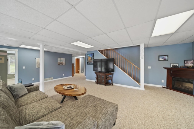 11259 Baker Rd, Jerome, MI 49249 - living area featuring stairway, a drop ceiling, carpet floors, and a glass covered fireplace