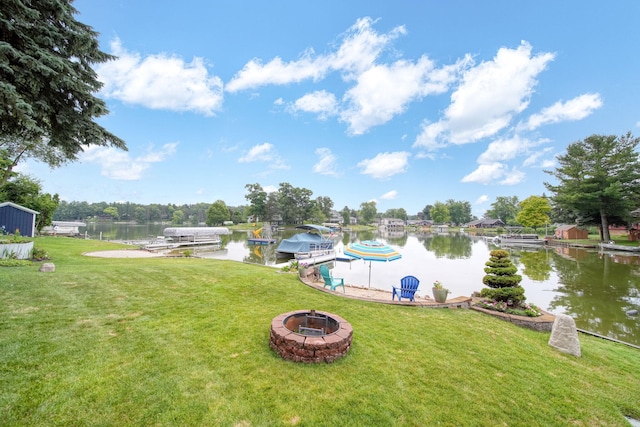 11259 Baker Rd, Jerome, MI 49249 - dock featuring an outdoor fire pit, a water view, and a yard