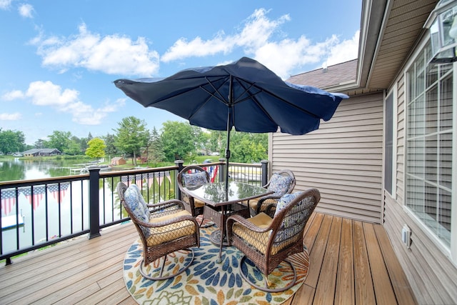 11259 Baker Rd, Jerome, MI 49249 - wooden deck featuring outdoor dining area and a water view