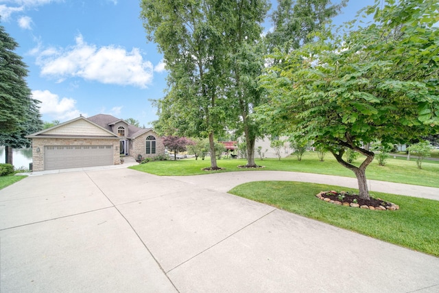11259 Baker Rd, Jerome, MI 49249 - view of front facade with driveway, a front yard, an attached garage, and stone siding