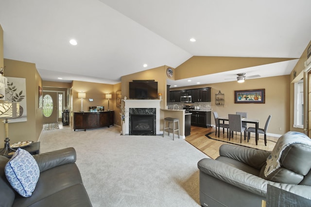 11259 Baker Rd, Jerome, MI 49249 - living room featuring vaulted ceiling, ceiling fan, a premium fireplace, light carpet, and recessed lighting