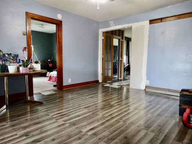 1570 Evon Rd, Saginaw, MI 48601 - living room featuring wood finished floors and a baseboard heating unit