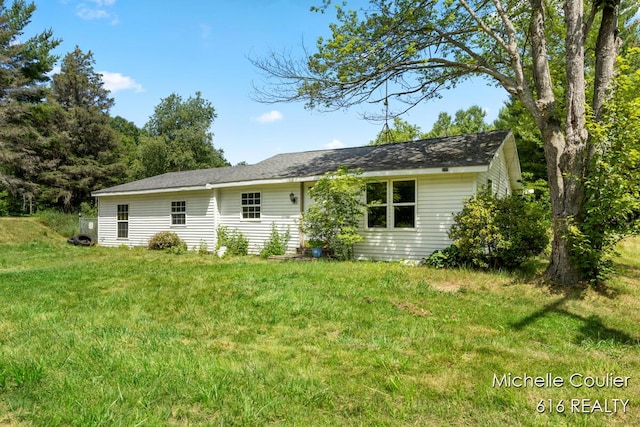 9583 E 5 Mile Rd, Big Rapids, MI 49307 - rear view of property featuring a yard