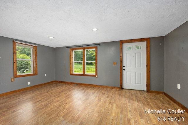 9583 E 5 Mile Rd, Big Rapids, MI 49307 - entrance foyer featuring light wood-style flooring, a textured ceiling, and recessed lighting