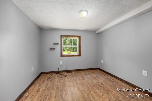 9583 E 5 Mile Rd, Big Rapids, MI 49307 - spare room with wood finished floors and baseboards