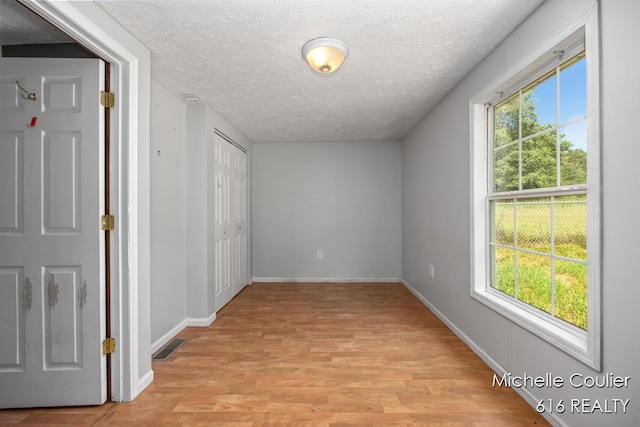 9583 E 5 Mile Rd, Big Rapids, MI 49307 - hall featuring a textured ceiling and light wood-style flooring