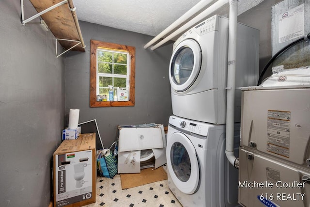 9583 E 5 Mile Rd, Big Rapids, MI 49307 - laundry room with stacked washer / drying machine, tile patterned floors, and a textured ceiling