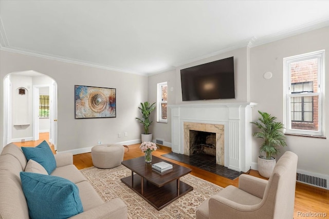 11110 Wayburn St, Grosse Pointe, MI 48224 - living room with wood finished floors, arched walkways, crown molding, and a premium fireplace