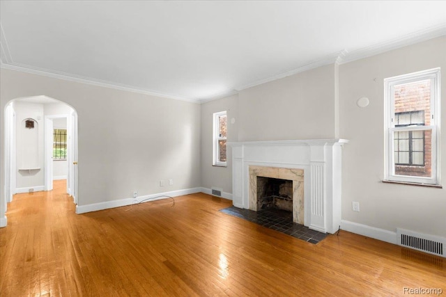 11110 Wayburn St, Grosse Pointe, MI 48224 - unfurnished living room featuring wood finished floors, arched walkways, a high end fireplace, and ornamental molding