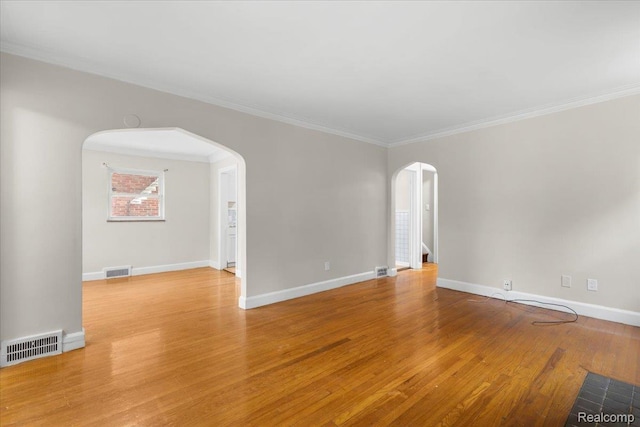 11110 Wayburn St, Grosse Pointe, MI 48224 - empty room featuring arched walkways, wood finished floors, and crown molding