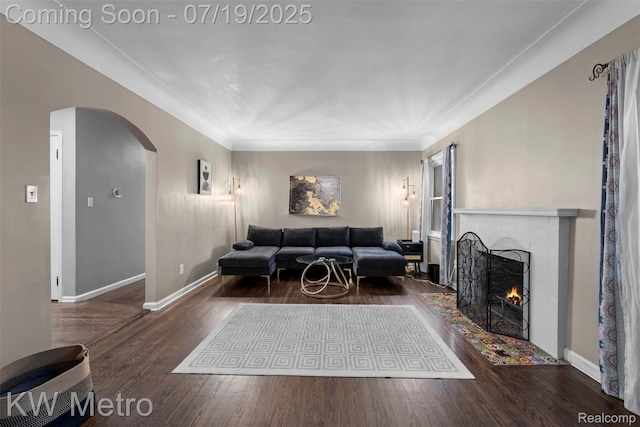 972 Goodale Ave, Clawson, MI 48017 - living area with arched walkways, wood finished floors, and a brick fireplace