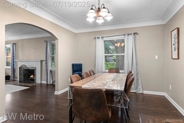 972 Goodale Ave, Clawson, MI 48017 - dining room with arched walkways, wood finished floors, a brick fireplace, and a chandelier