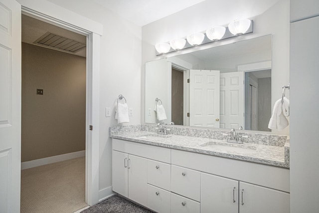 7751 Austinridge Dr SE, Caledonia, MI 49316 - bathroom with double vanity and baseboards
