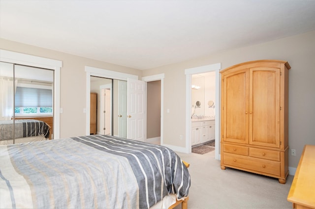 7751 Austinridge Dr SE, Caledonia, MI 49316 - bedroom featuring multiple closets, light colored carpet, and ensuite bathroom