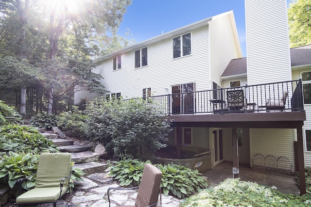 7751 Austinridge Dr SE, Caledonia, MI 49316 - rear view of house with a deck and a chimney