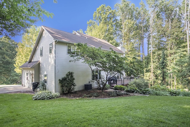 7751 Austinridge Dr SE, Caledonia, MI 49316 - view of side of home with a lawn and roof with shingles