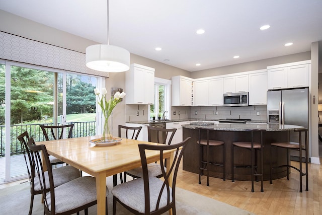 7751 Austinridge Dr SE, Caledonia, MI 49316 - dining area with plenty of natural light, light wood finished floors, and recessed lighting