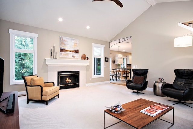 7751 Austinridge Dr SE, Caledonia, MI 49316 - living area with a fireplace with flush hearth, recessed lighting, carpet, ceiling fan, and high vaulted ceiling