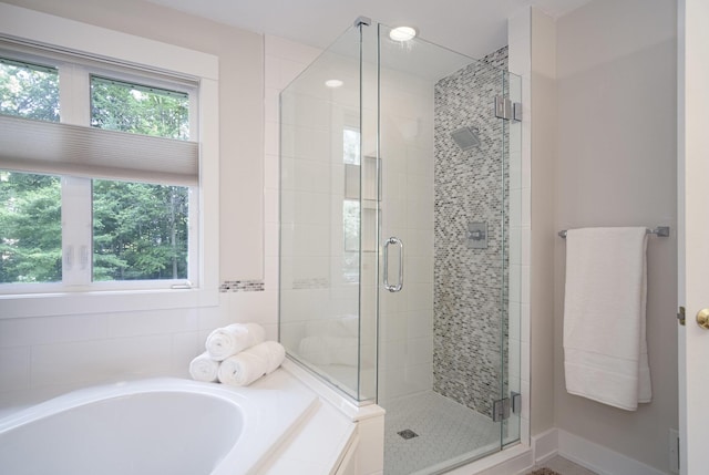 7751 Austinridge Dr SE, Caledonia, MI 49316 - bathroom featuring a garden tub and a shower stall