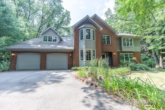 6340 Cannon Highlands Dr NE, Belmont, MI 49306 - view of front of house with brick siding, driveway, and a garage