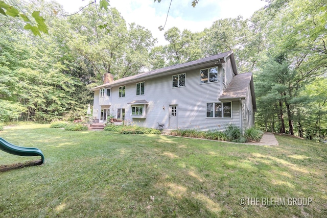 6340 Cannon Highlands Dr NE, Belmont, MI 49306 - back of house with a chimney, a lawn, and a playground