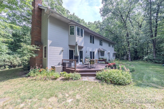 6340 Cannon Highlands Dr NE, Belmont, MI 49306 - rear view of house featuring a chimney, a lawn, and a wooden deck