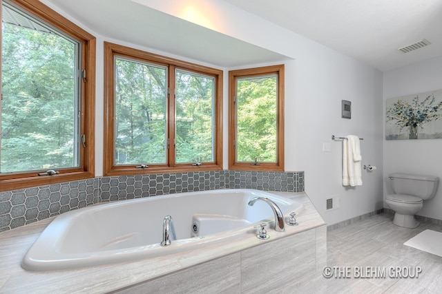 6340 Cannon Highlands Dr NE, Belmont, MI 49306 - bathroom with a whirlpool tub and toilet