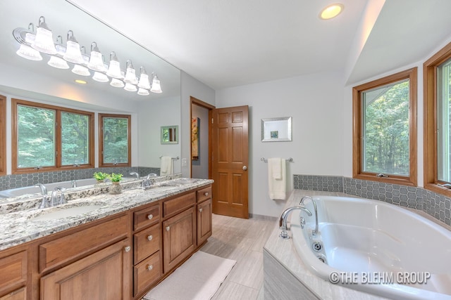 6340 Cannon Highlands Dr NE, Belmont, MI 49306 - bathroom with double vanity and a whirlpool tub