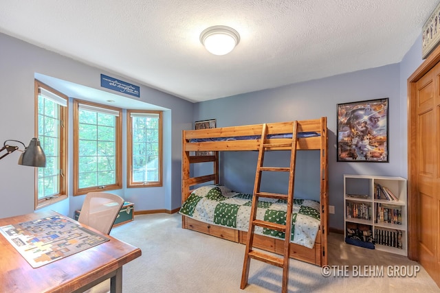 6340 Cannon Highlands Dr NE, Belmont, MI 49306 - carpeted bedroom featuring baseboards and a textured ceiling