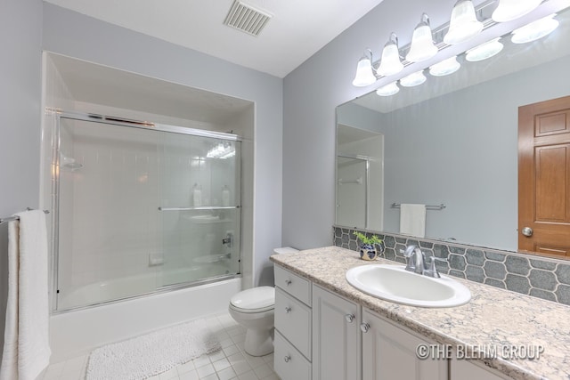 6340 Cannon Highlands Dr NE, Belmont, MI 49306 - full bath with vanity, bath / shower combo with glass door, tile patterned flooring, and tasteful backsplash