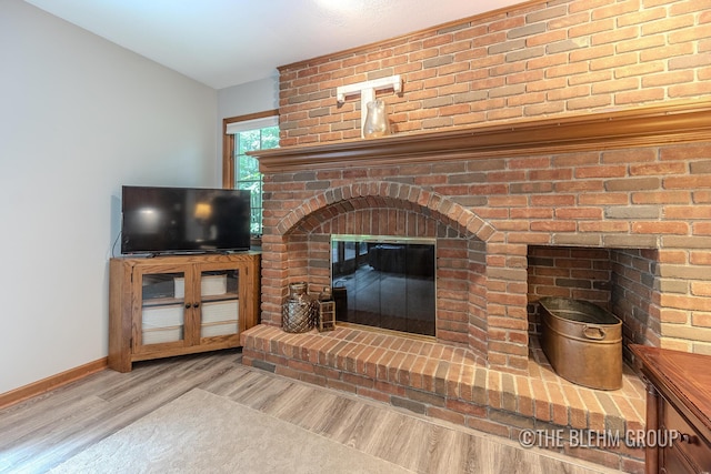 6340 Cannon Highlands Dr NE, Belmont, MI 49306 - living area with wood finished floors and a brick fireplace