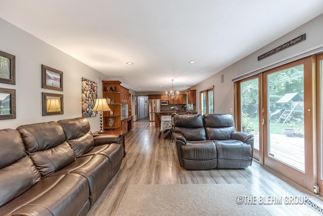 6340 Cannon Highlands Dr NE, Belmont, MI 49306 - living area featuring a chandelier, recessed lighting, and light wood-style flooring