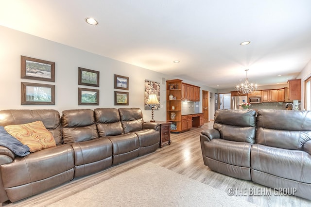 6340 Cannon Highlands Dr NE, Belmont, MI 49306 - living area featuring a chandelier, recessed lighting, and light wood-style flooring