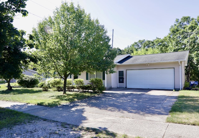 1340 Elmdale St NE, Grand Rapids, MI 49525 - view of front of house featuring a garage, concrete driveway, and a front lawn