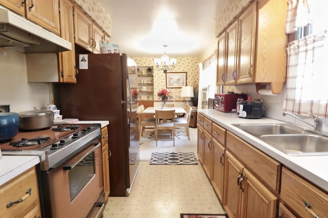 1340 Elmdale St NE, Grand Rapids, MI 49525 - kitchen featuring gas range, under cabinet range hood, light floors, healthy amount of natural light, and wallpapered walls